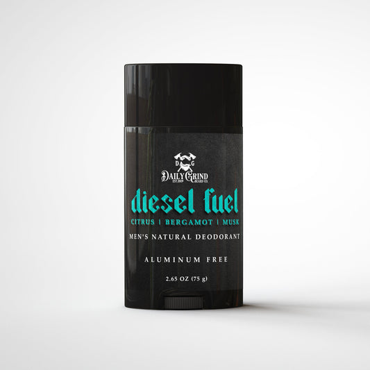 Daily Grind Diesel Fuel Deodorant in citrus, bergamot, and musk scent, natural deodorant for men shown in a matte black twist-up stick on a white background