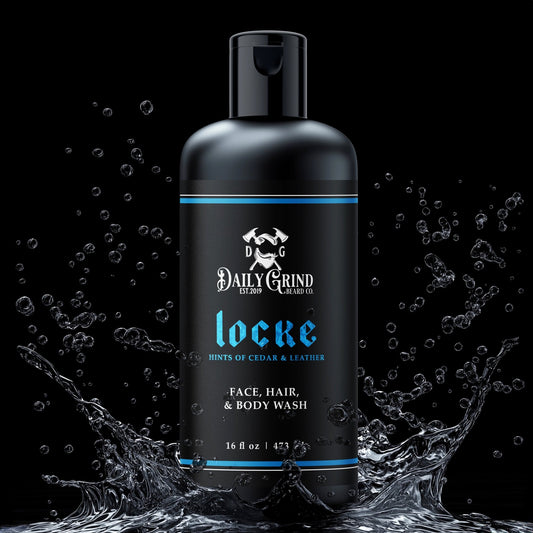 Daily Grind Locke Face Hair and Body Wash in Cedar and Leather scent, 3-in-1 shampoo and cleanser for men shown in a matte black bottle with blue accents surrounded by splashing water