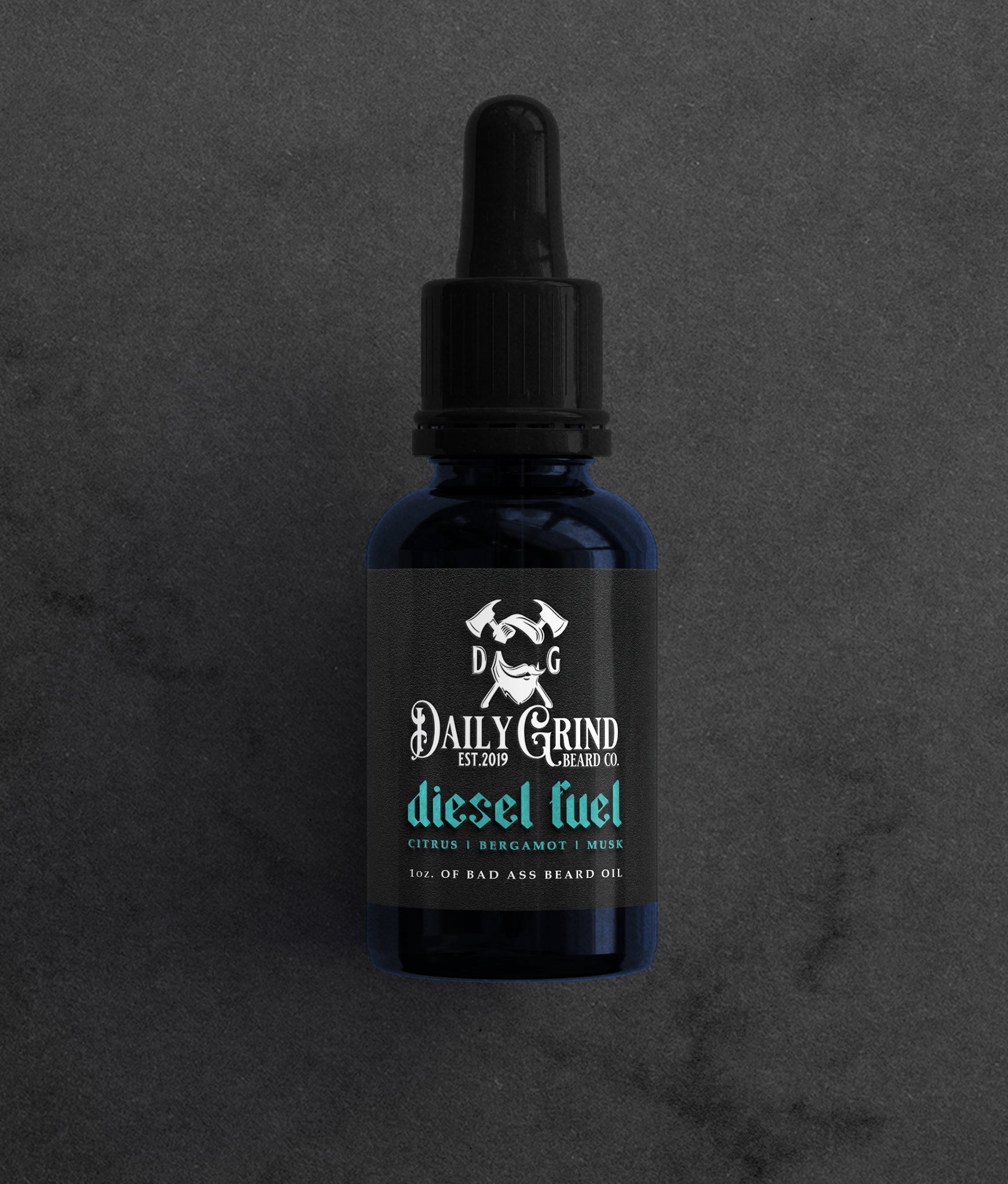 Diesel Fuel citrus bergamot musk beard oil for men by Daily Grind in a blue bottle on a dark stone background