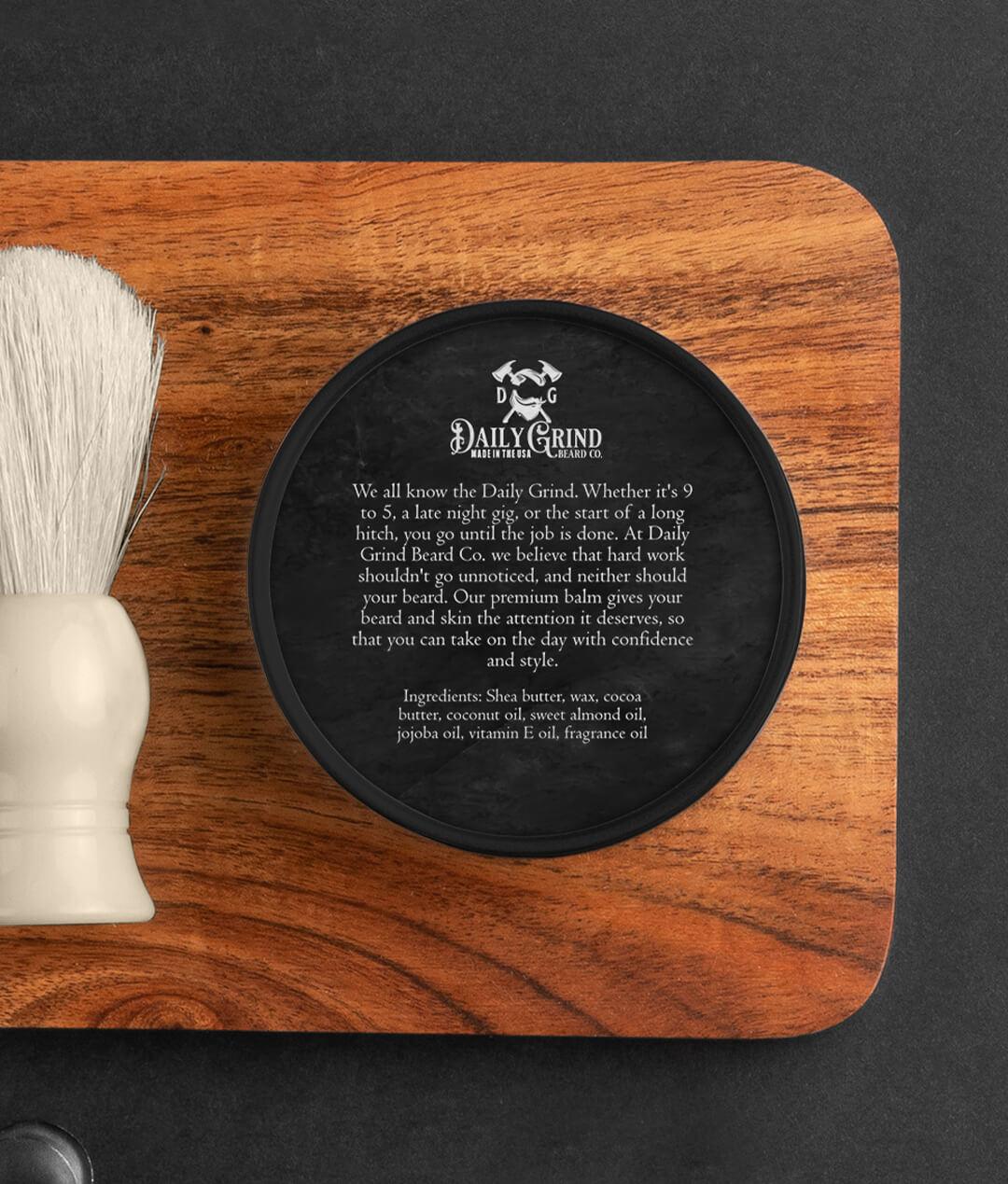 Ingredients label for Daily Grind Locke Beard Balm in Cedar and Leather scent, beard conditioner and moisturizer for men shown in a black tin on a grooming table