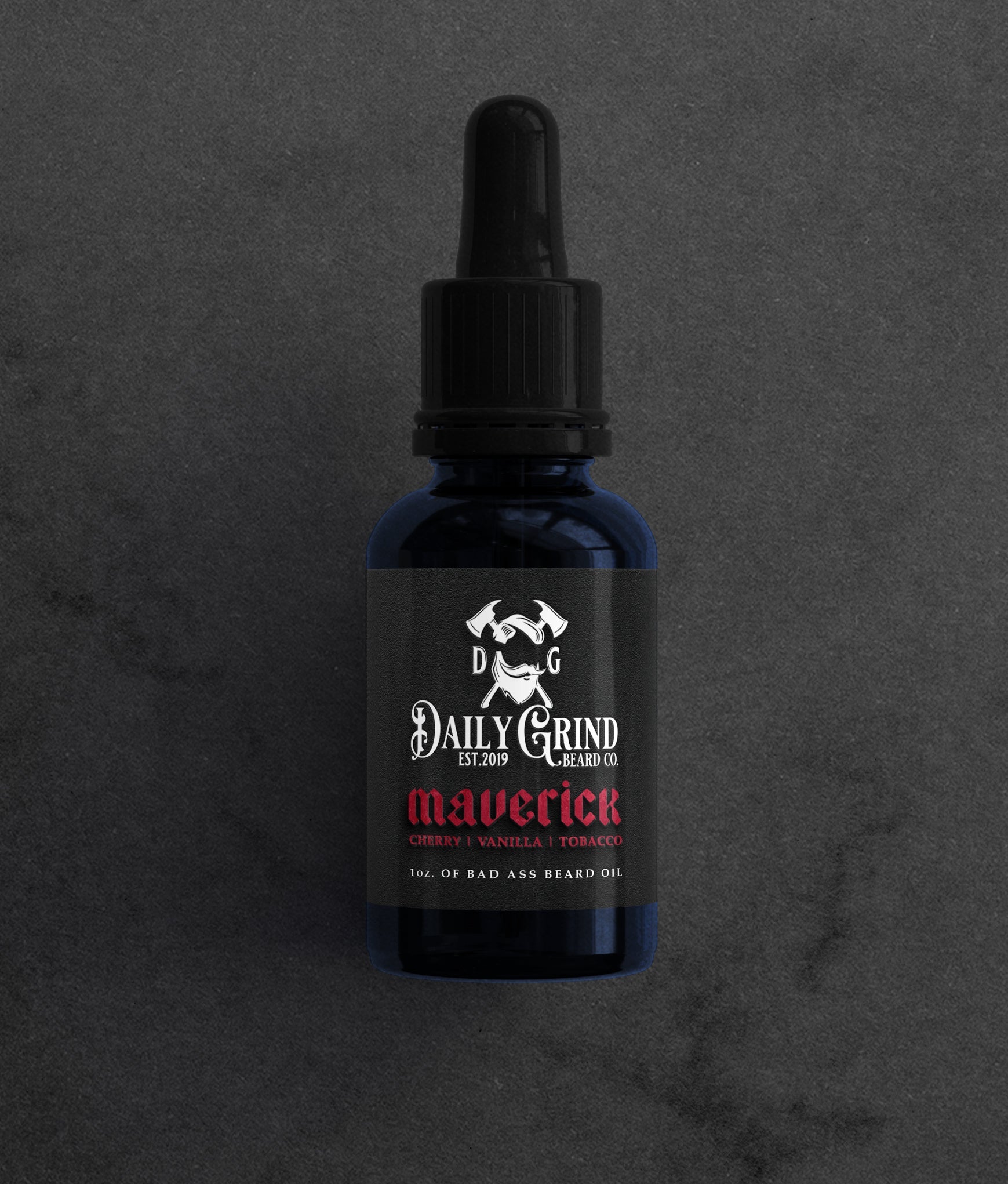 Dark blue glass bottle of Daily Grind Maverick Beard Oil (Cherry Vanilla Tobacco scent) with dropper top on a textured background.